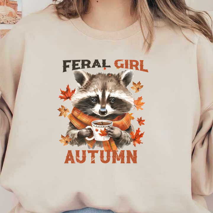 Un lindo mapache con una bufanda disfruta de una bebida caliente, rodeado de hojas de otoño, con las palabras "Feral Girl Autumn".