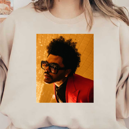 A stylish individual sports a bold red suit and oversized sunglasses, exuding confidence against a shimmering golden backdrop.DTF Transfers dtf prints