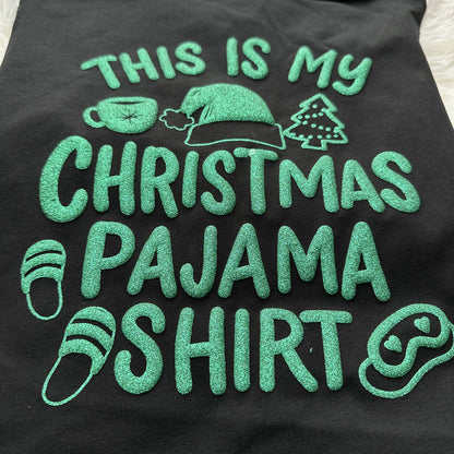 Celebrate the holidays in style with this black Christmas pajama shirt featuring fun green glitter text and festive icons!DTF Transfers puff