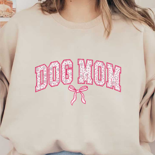 "Dog Mom" pink and white bow and paw print design on a green background.DTF Transfers
