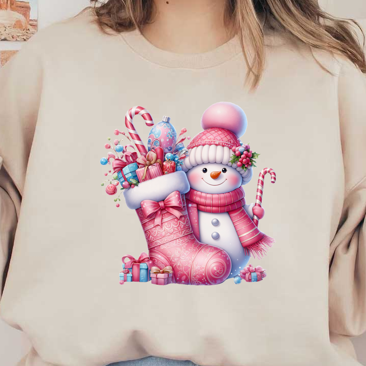 A cheerful snowman in a pink knitted hat stands beside a festive pink stocking filled with gifts and candy canes. heat press transfers