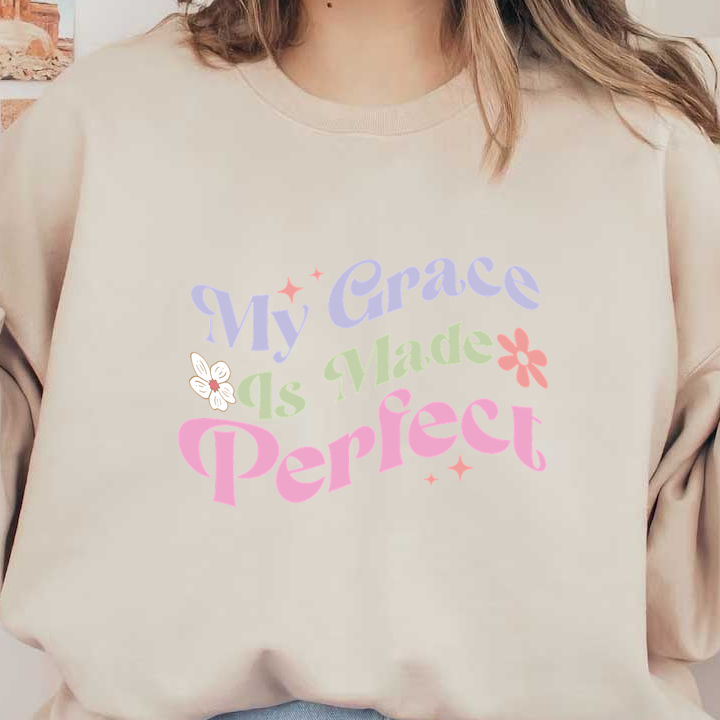 A colorful, uplifting graphic design featuring the phrase "My Grace Is Made Perfect," adorned with flowers and playful typography. heat press transfers