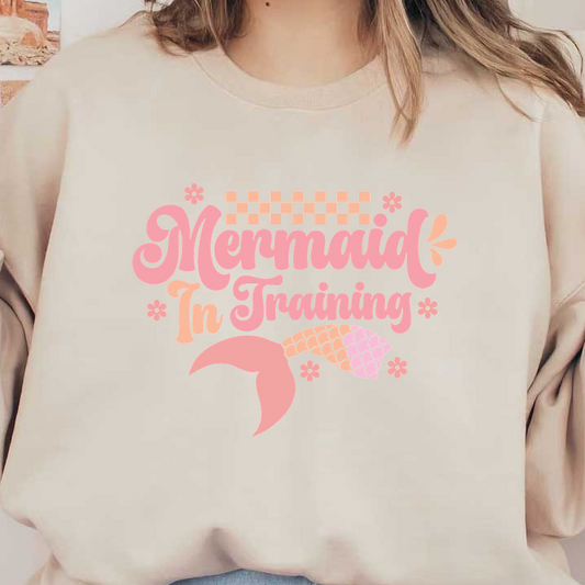 Cute design featuring the phrase "Mermaid In Training" with a playful mermaid tail and floral accents in pastel pink tones.DTF Transfers