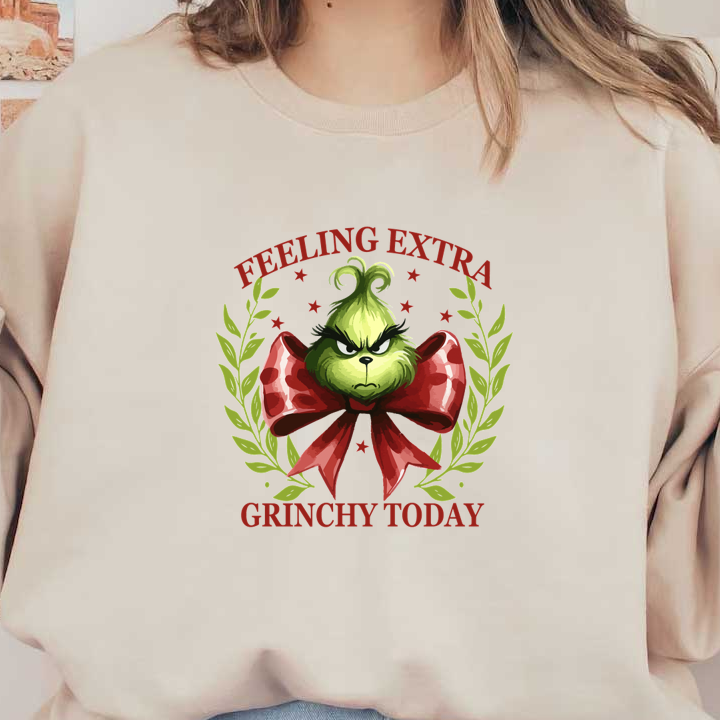 A whimsical design featuring the Grinch with a red bow, proclaiming "Feeling Extra Grinchy Today," surrounded by festive greenery. heat press transfers